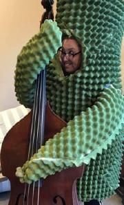 Syndenn dressed as a saguaro with a double bass.