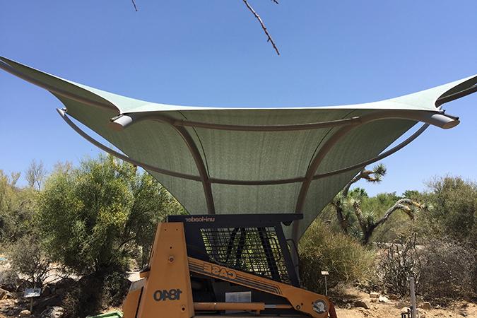 Exhibit construction continues under the newly erected shade structure